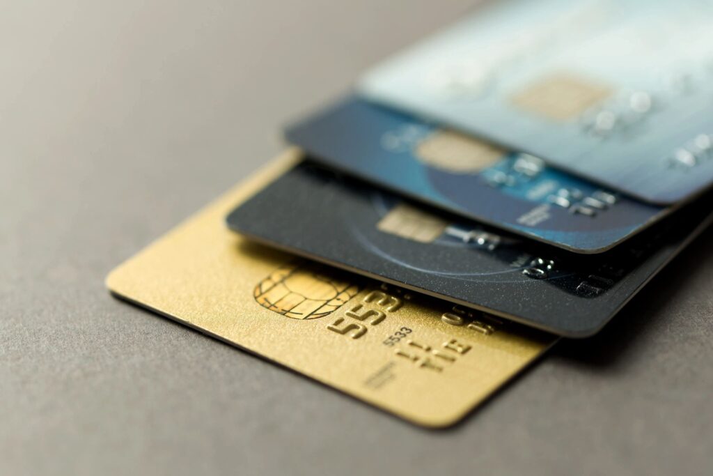A close up of three credit cards on top of each other.