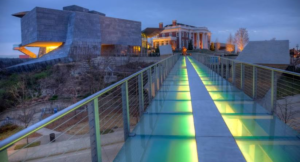A walkway with lights on the side of it.