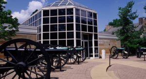A building with a large glass window and a horse drawn carriage.