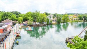 A lake with boats docked in it and trees