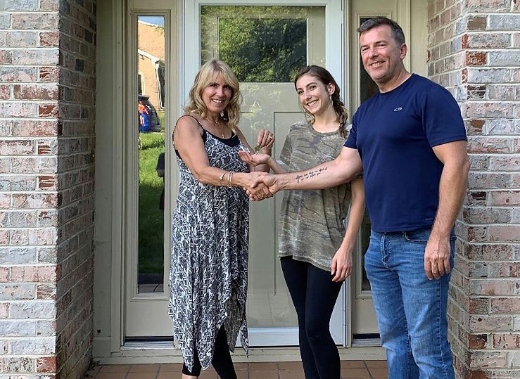 A couple of people standing in front of a door.