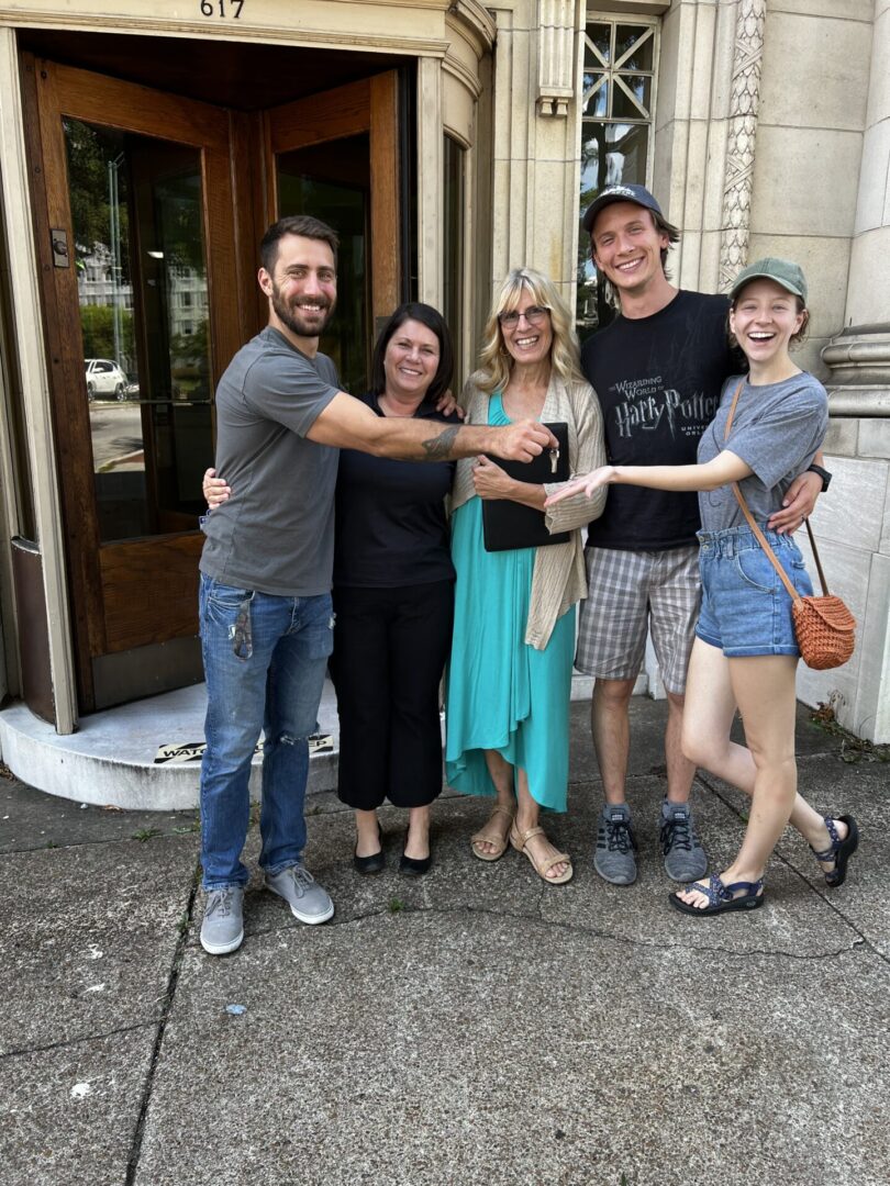 A group of people standing outside of a building.